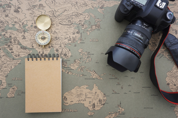 travel-composition-with-compass-camera-and-notebook_23-2147607770